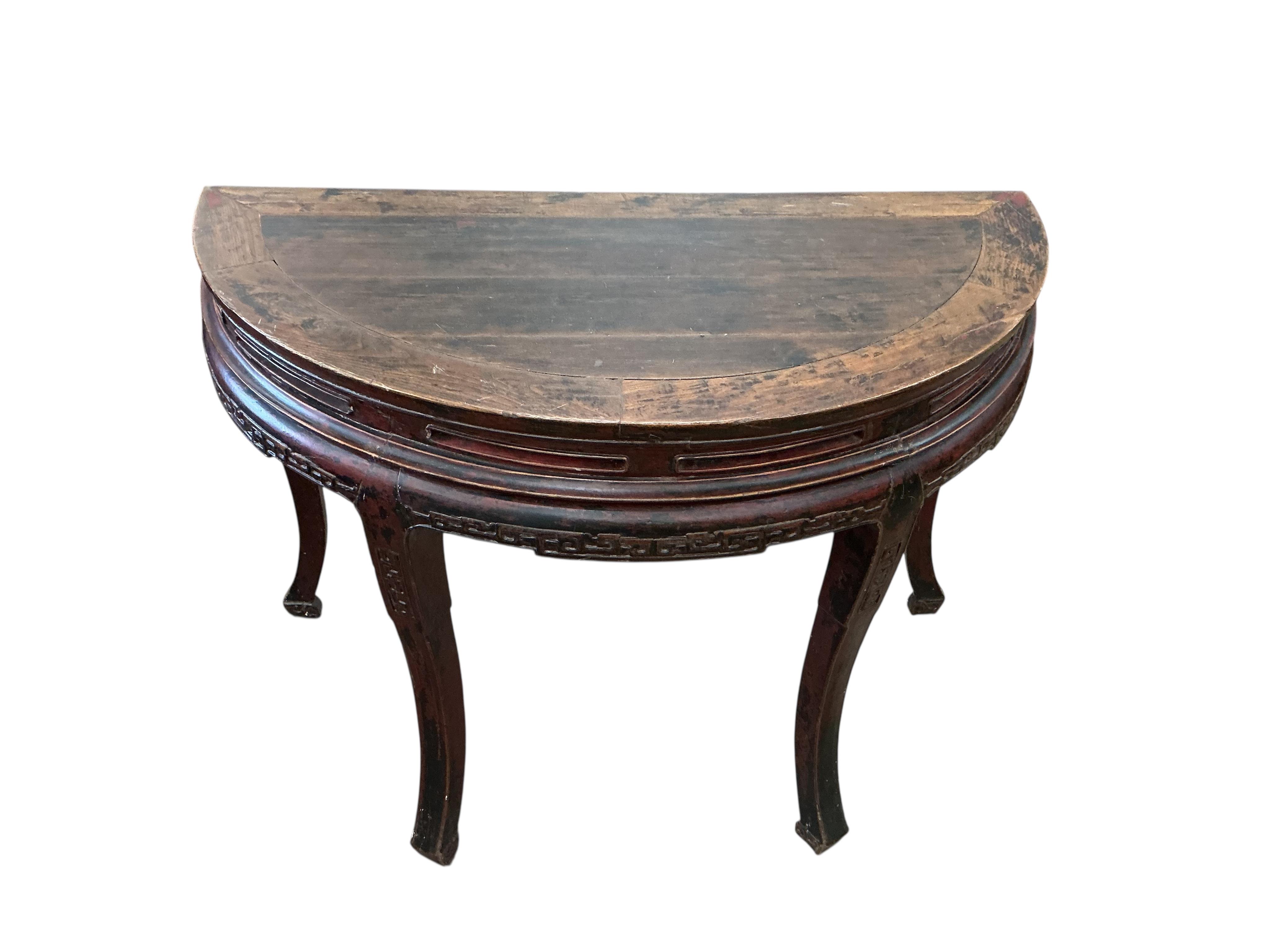 A pair of Chinese part lacquered demi lune console tables, width 124cm, depth 63cm, height 90cm